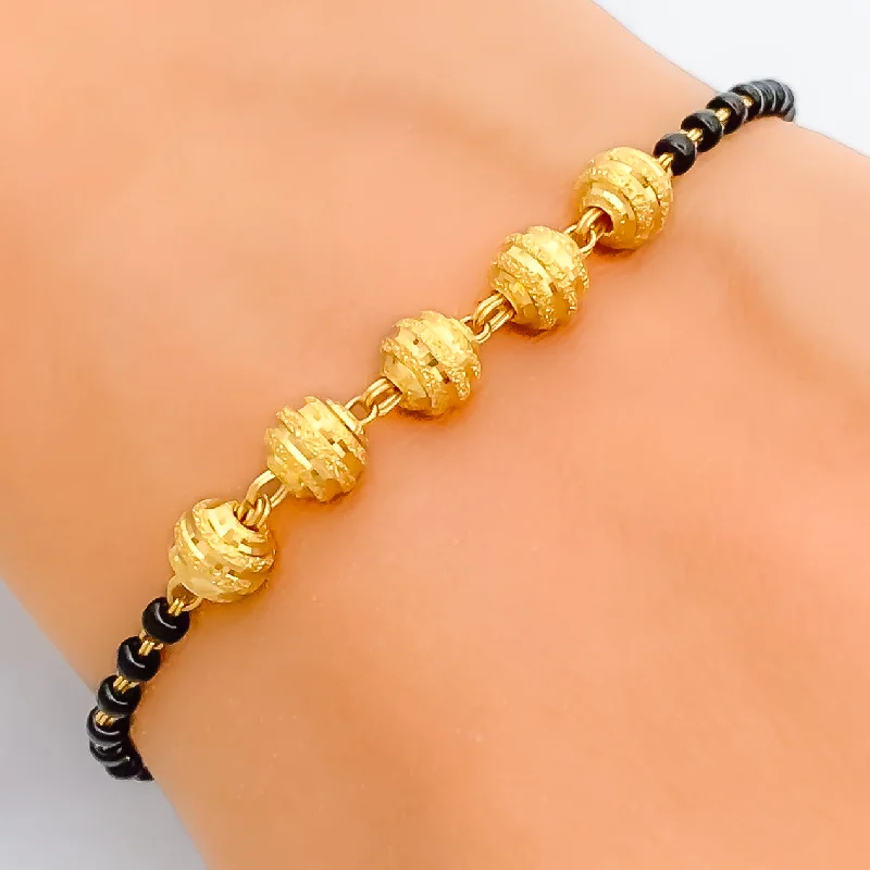 Radiant Ornate 22k Gold Black Bead Bracelet